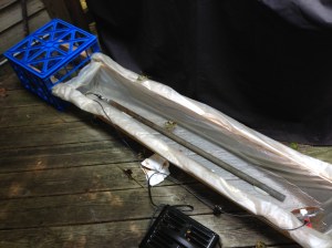 The "trough", created out of two milk crates, two 2x2 pieces of lumber, and an old shower curtain liner.